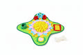 Dog sitting next to a colorful dog puzzle mat on a table. from shop ThinkyPets