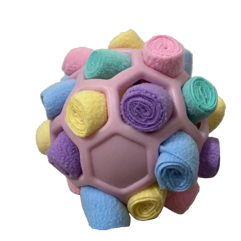Colorful textured ball held in a hand against a plain background  on the shop ThinkyPets