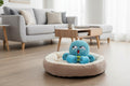 Blue octopus-shaped pet toy used for sniffling  with a dog interacting with it on a white background from shop ThinkyPets