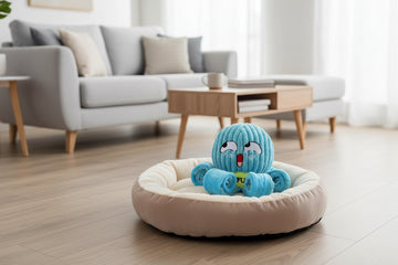 Blue octopus-shaped pet toy used for sniffling  with a dog interacting with it on a white background from shop ThinkyPets