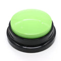 Green button with black base on a white background