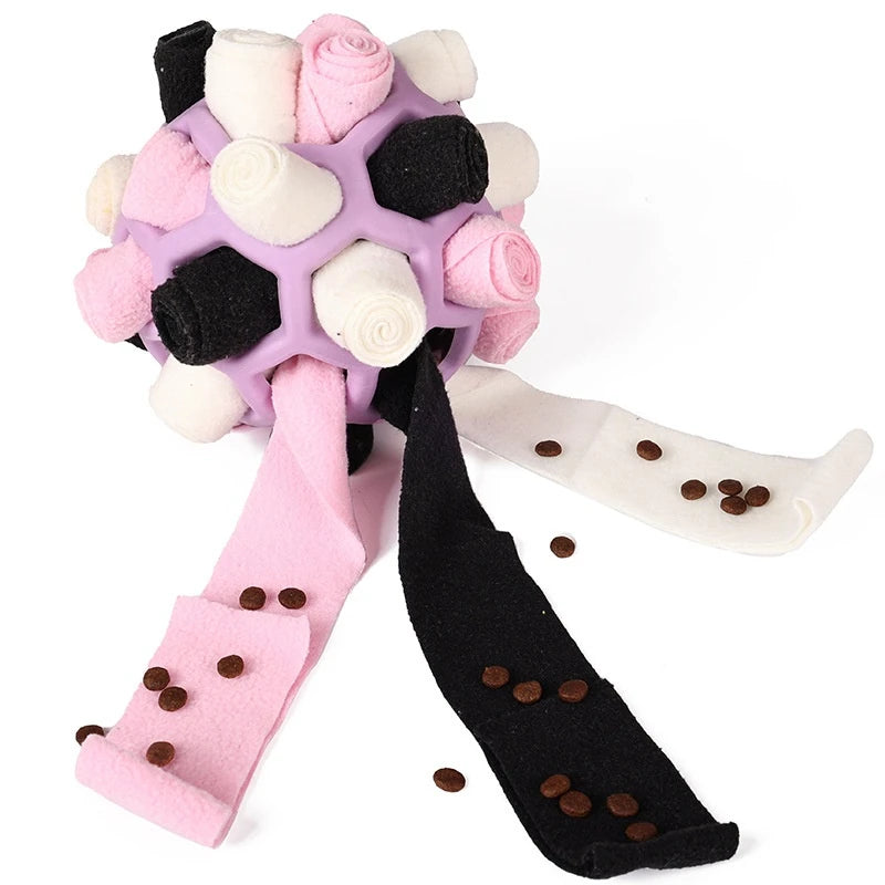 Colorful dog toy with pink and black ribbons and scattered treats on a white background  on the shop ThinkyPets