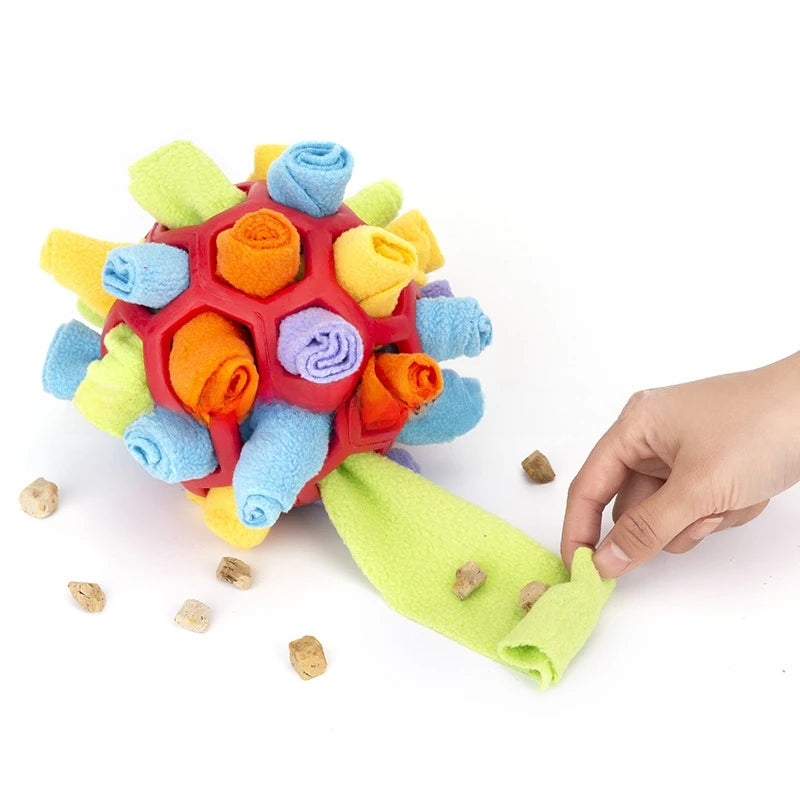Dog playing with a colorful hedgehog-shaped toy on grass sold by thinkyPets
