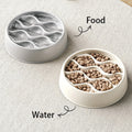 Two pet bowls, one for water and one for food, on a light surface.