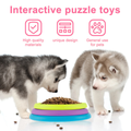 Two puppies interacting with a colorful puzzle toy on a white background supplied by ThinkyPets