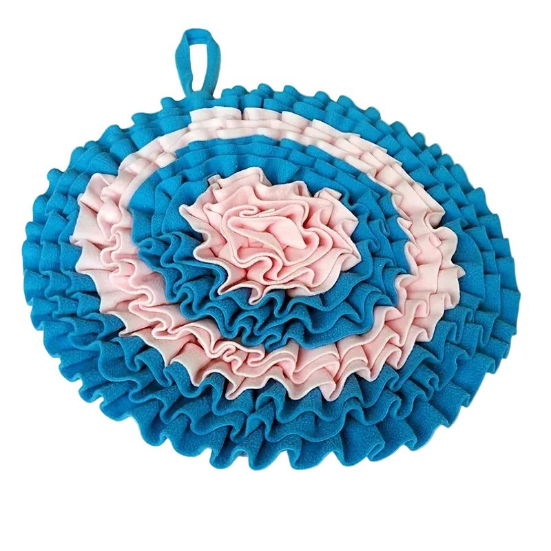 Round, textured dog snuffle matholder with blue and pink ruffled design on a white background