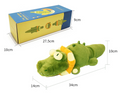 Green plush alligator toy with packaging, weight information, and dimensions on a white background.