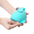 Turquoise silicone product being folded by a hand with text on a teal background