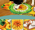 Dog playing with a colorful felt mat on a wooden floor
