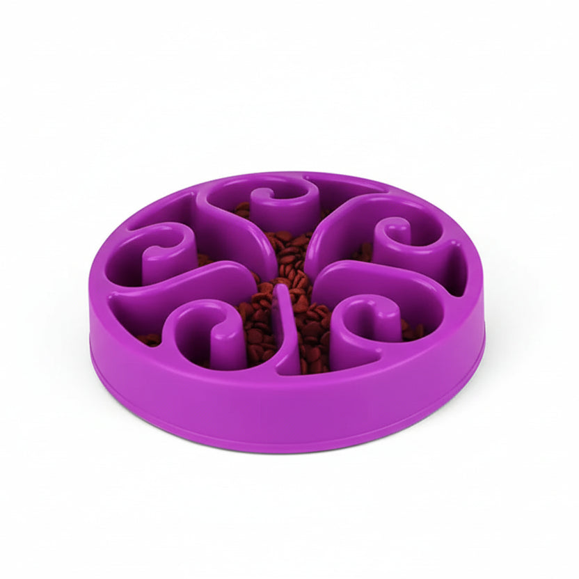 Purple slow feeder bowl with a dog eating from it on a white background