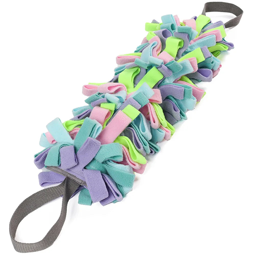Colorful dog toy with pastel ribbons on a white background