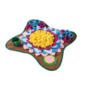 Dog sitting on a colorful pet mat with floral designs and a small cup. from shop ThinkyPets