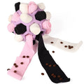 Colorful dog toy with pink and black ribbons and scattered treats on a white background  on the shop ThinkyPets